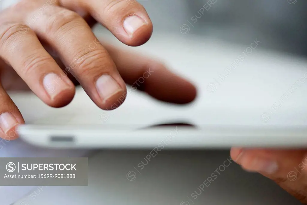 Man using touch screen on digital tablet, cropped