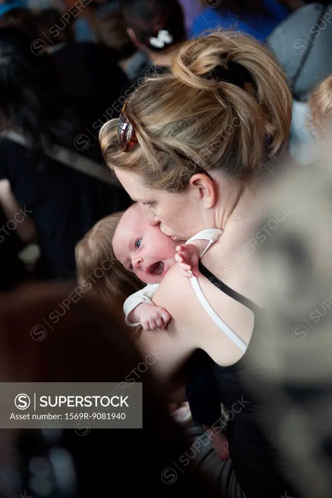 Mother kissing infant's cheek