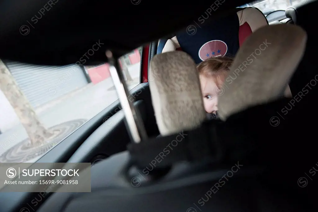 Little girl sitting in car seat