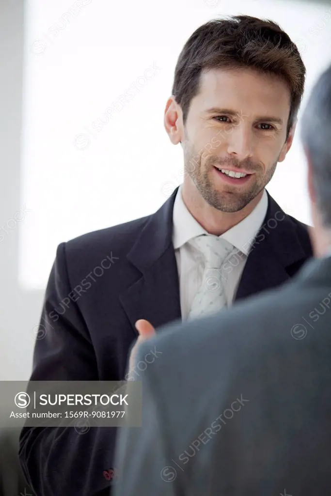 Businessman talking with colleague