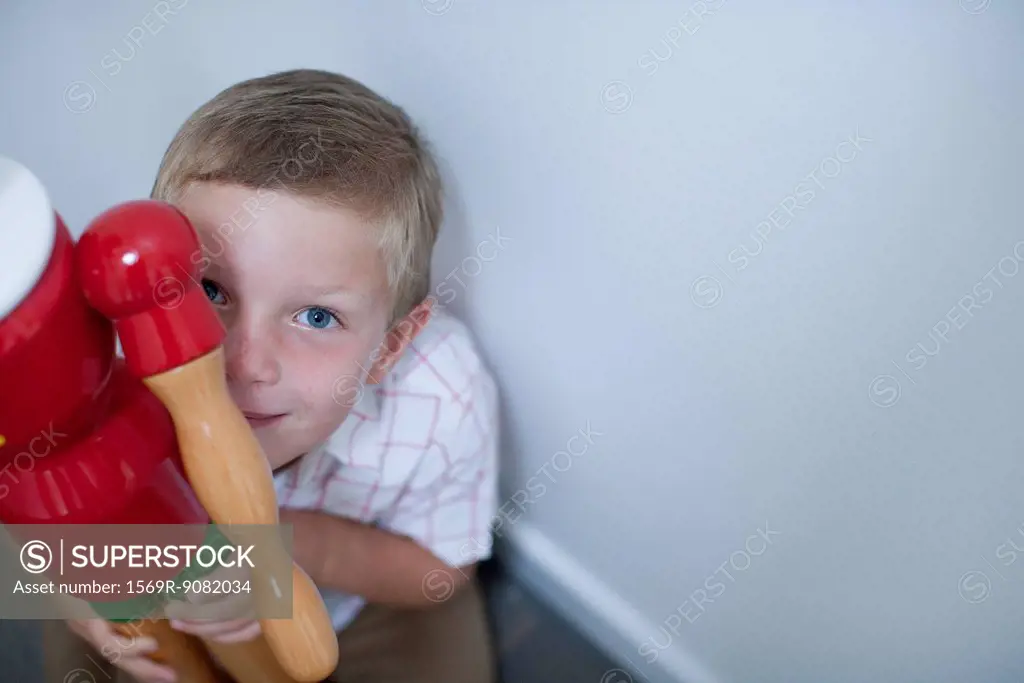 Boy holding toy, high angle view
