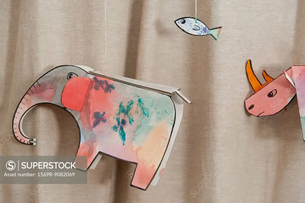Child's animal drawings hanging on strings