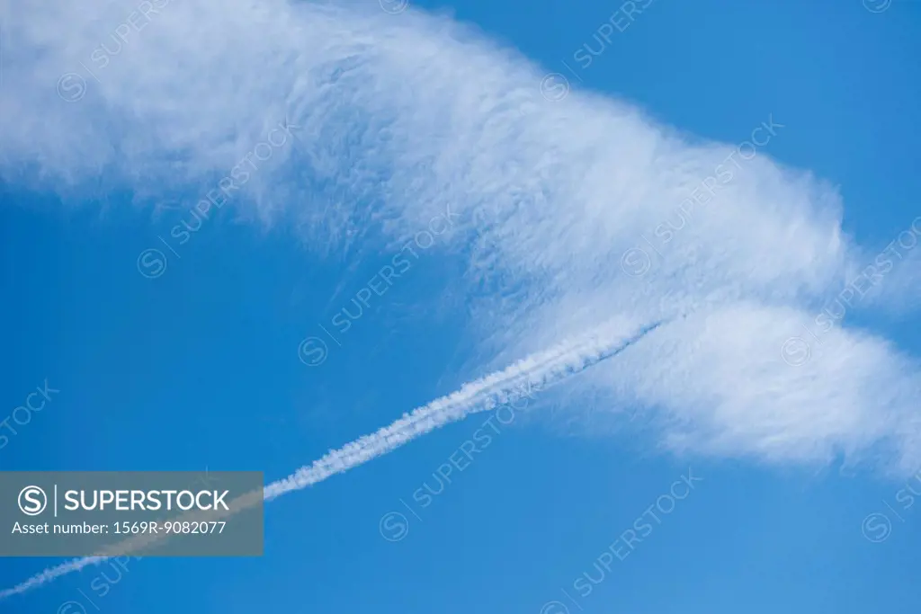 Clouds and vapor trail in blue sky
