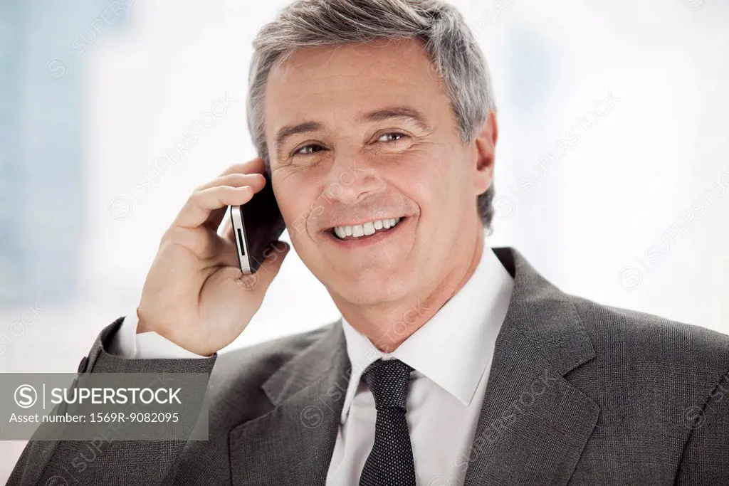 Business executive using cell phone, portrait