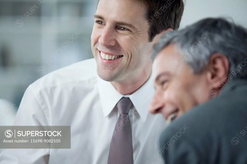 Businessmen smiling during meeting