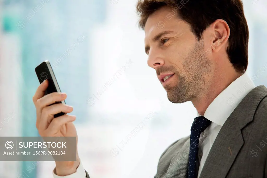 Businessman looking at cell phone