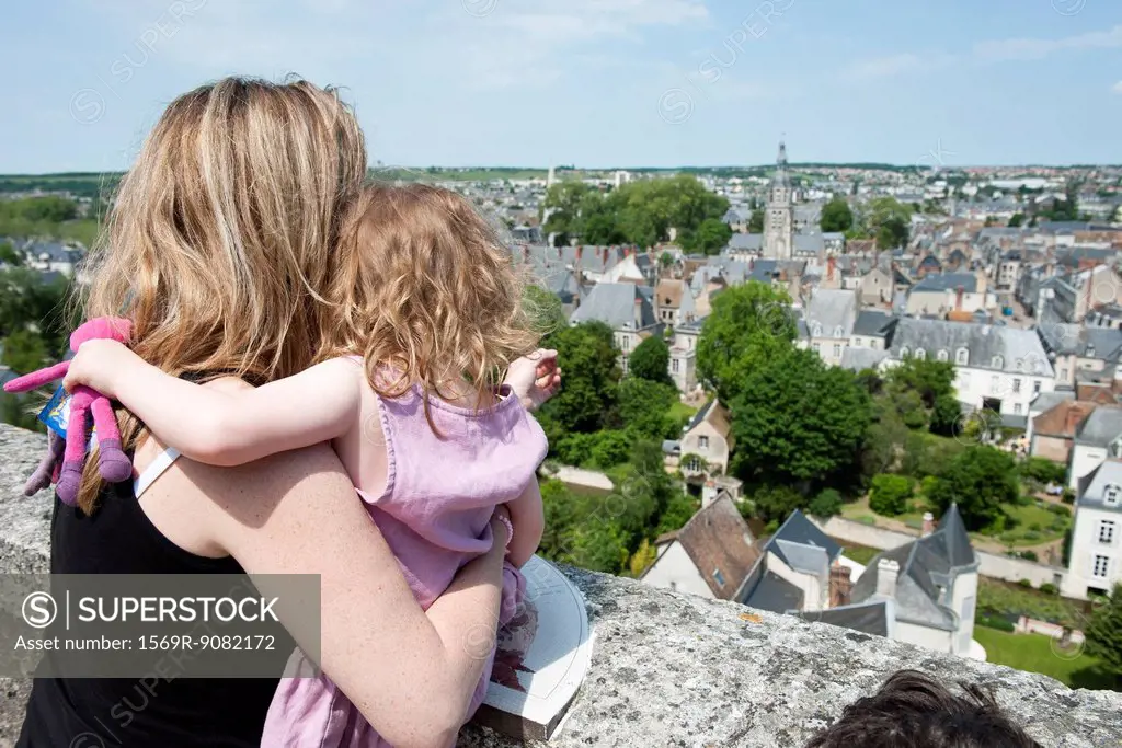 Mother and young daughter looking at view of Vendome, France