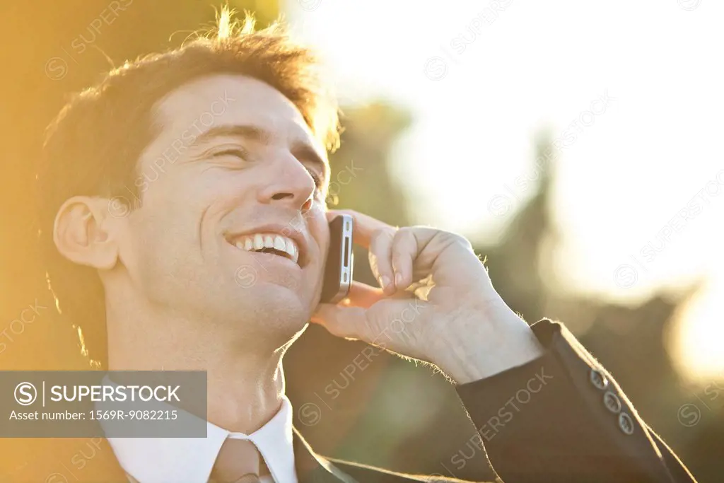 Businessman talking on cell phone, portrait