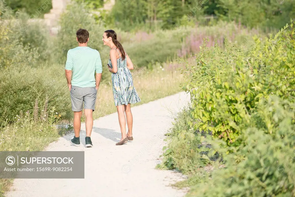Couple together on walk through park