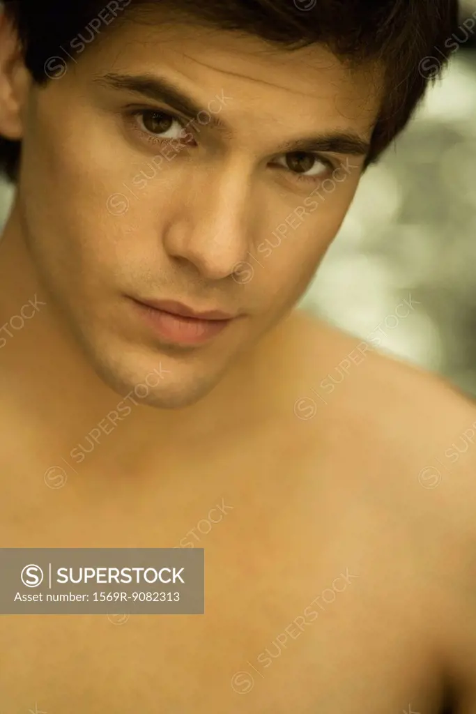 Barechested man looking seductively at camera, portrait