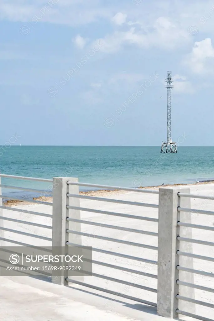 Barrier on beach, telecommunications tower in background