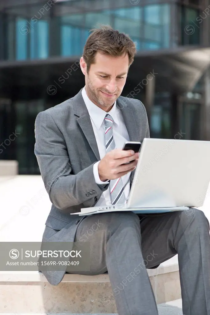 Businessman multitasking while working outdoors