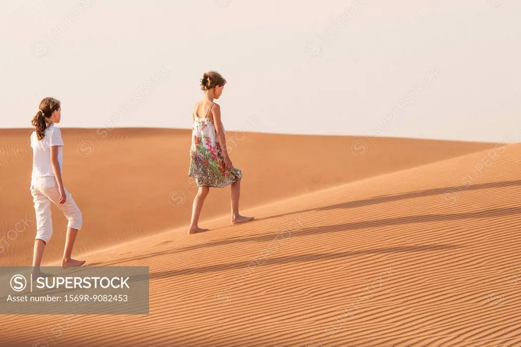 Girls walking in desert