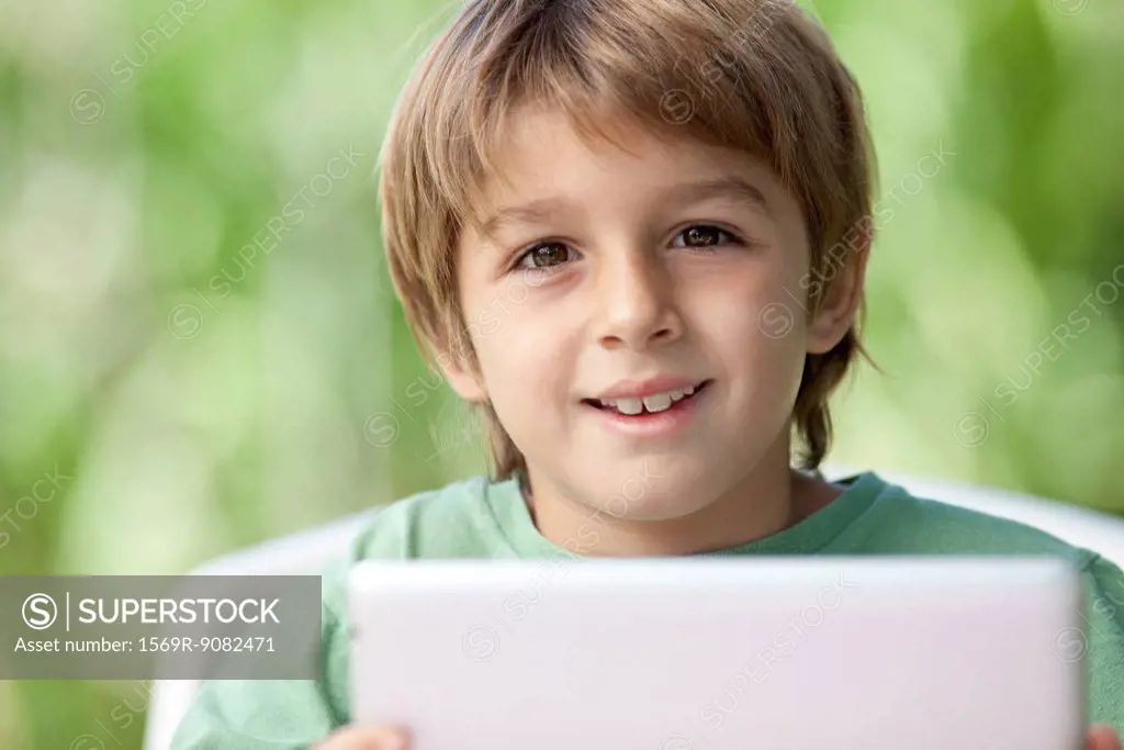 Boy holding digital tablet
