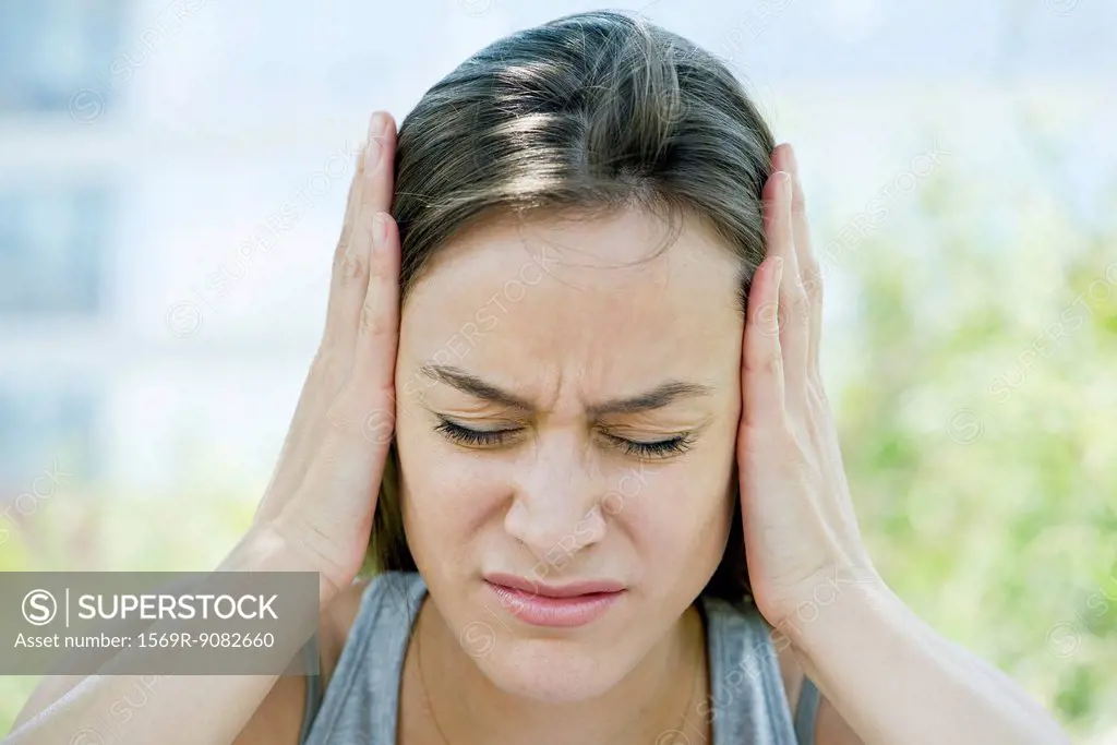 Distressed woman with head in hands