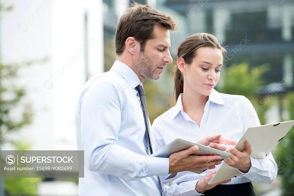 Business associates collaborating using digital tablet