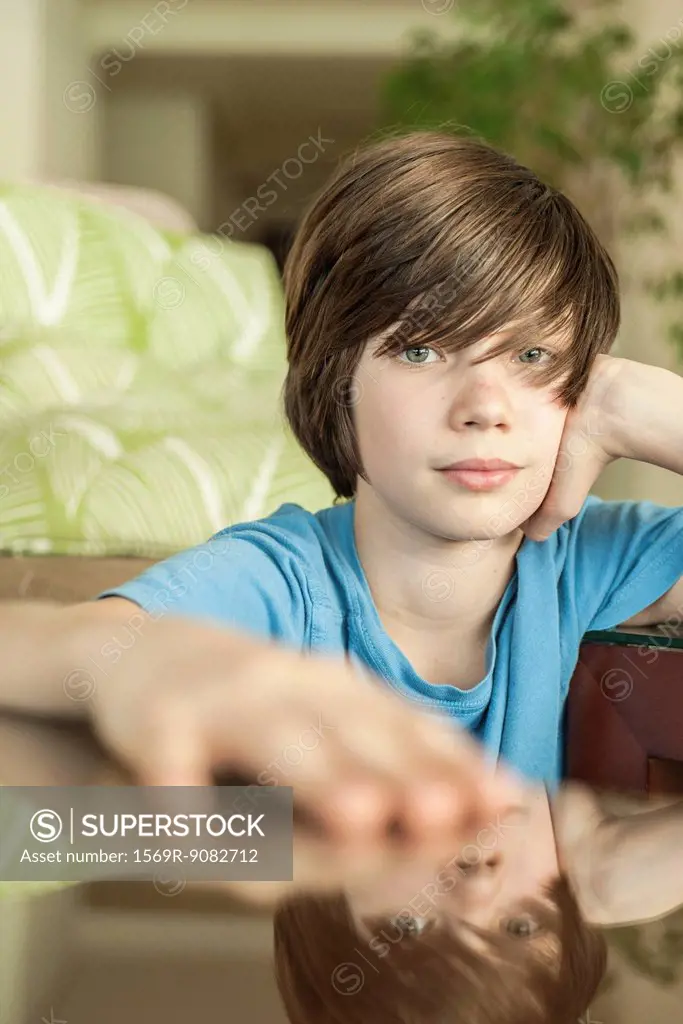 Teenage boy relaxing at home, portrait