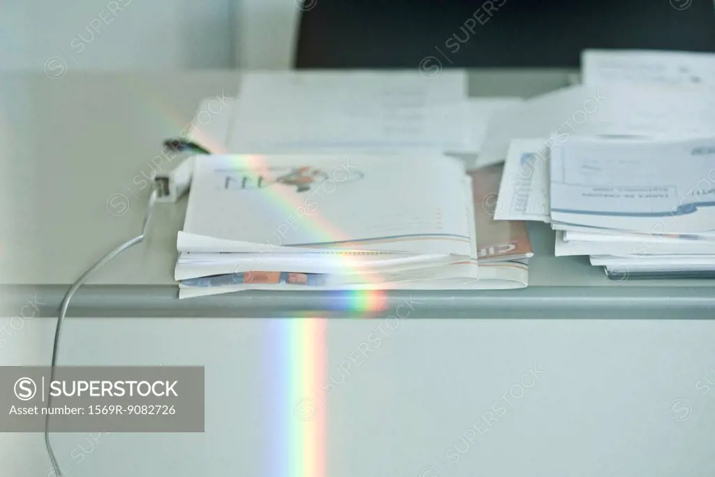 Rainbow refracted on desk in office