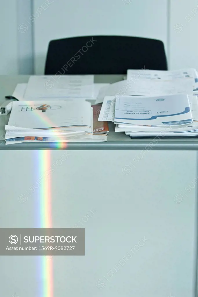 Rainbow refracted on desk in office