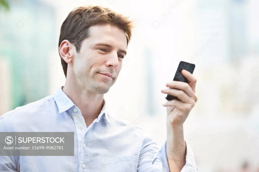 Mid-adult man checking cell phone