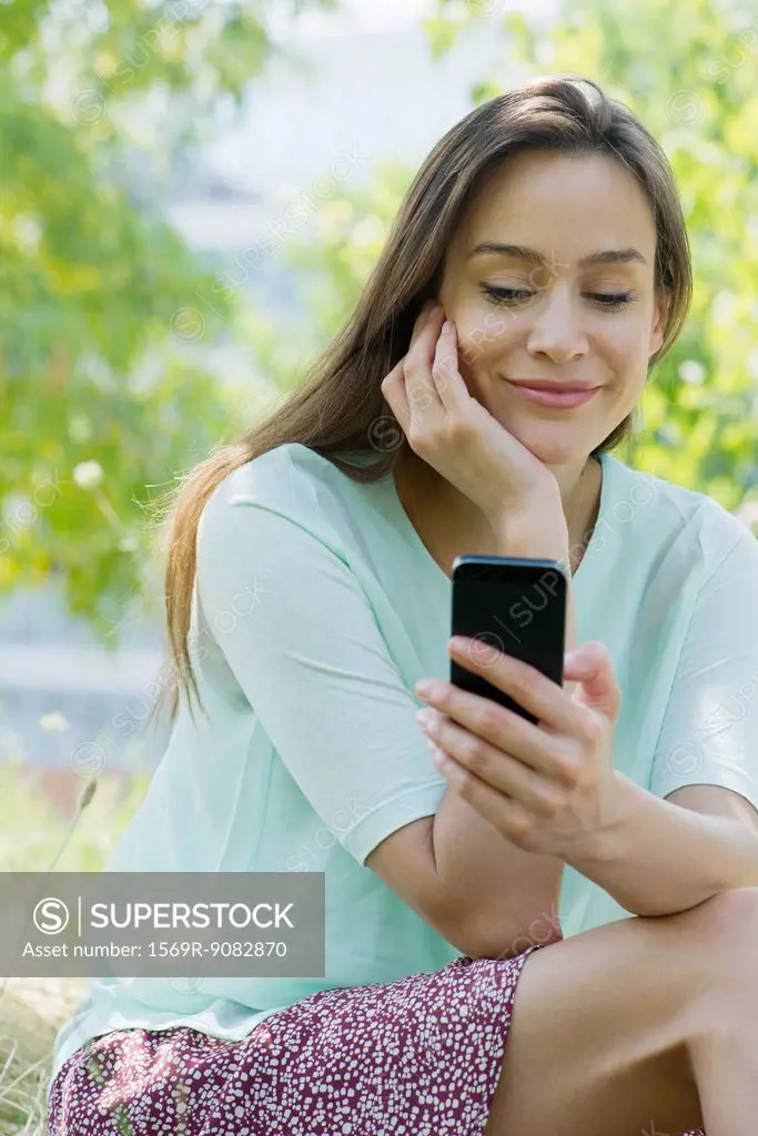 Woman looking at smartphone outdoors