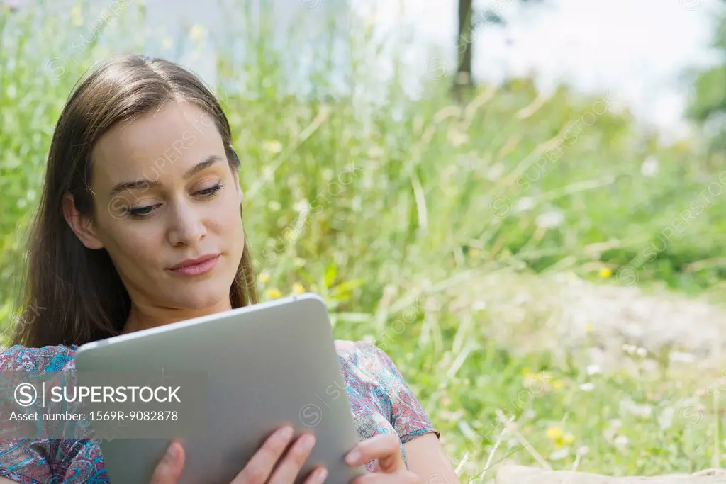 Woman using digital tablet outdoors