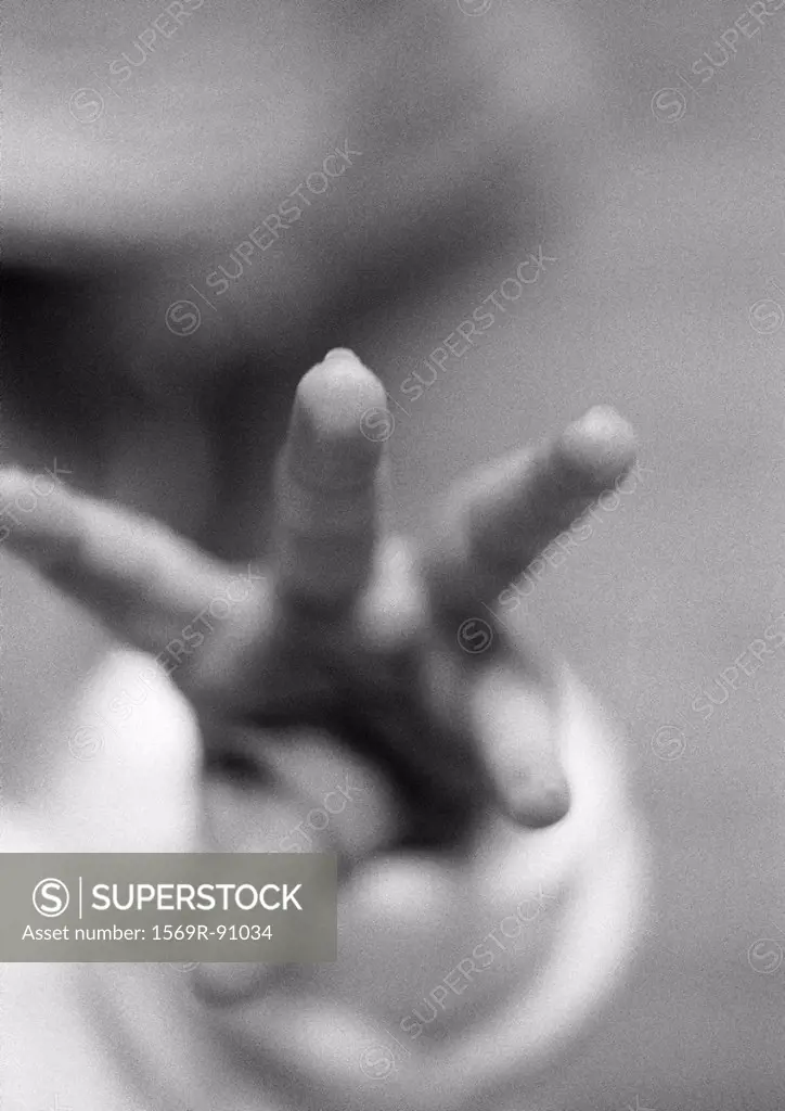 Baby´s fingers reaching, close-up, b&w