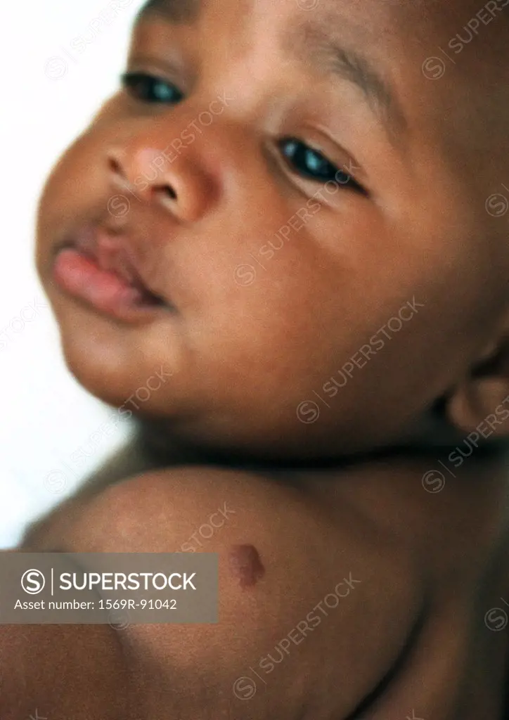 Baby looking over shoulder, close-up