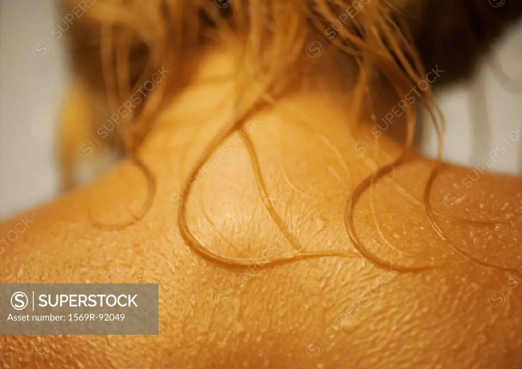 Woman´s wet bare upper back, close-up