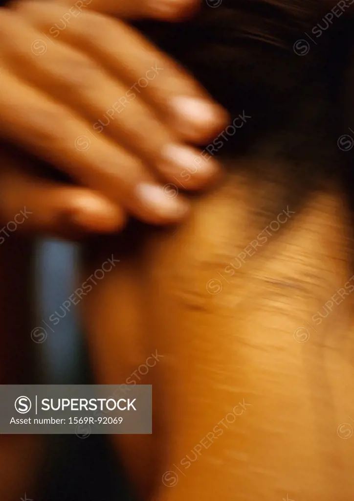 Woman´s fingers and neck, rear view, blurred close-up