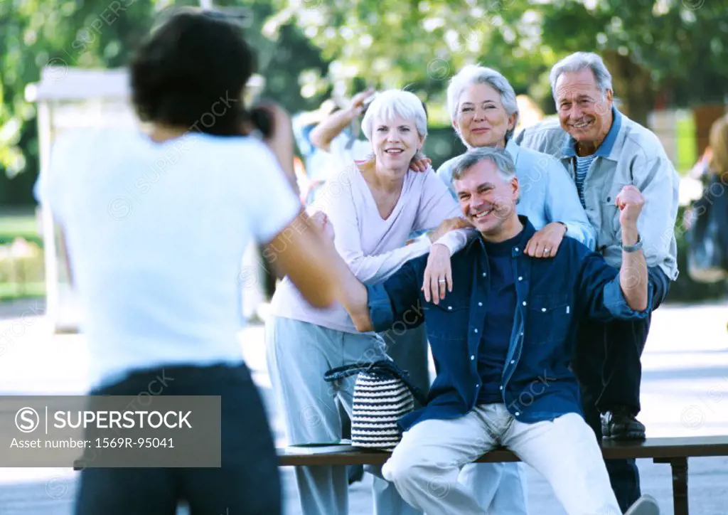 Group of mature people having their photo taken, blurred foreground