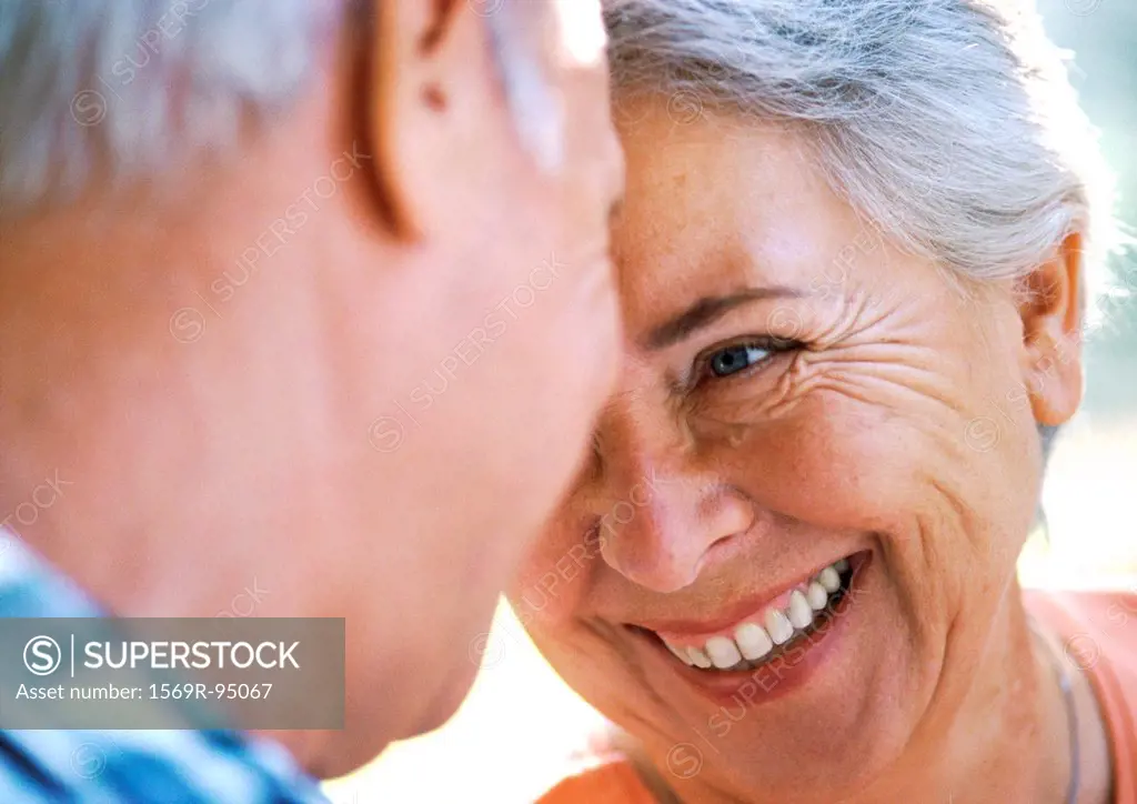 Mature man and woman smiling, close-up