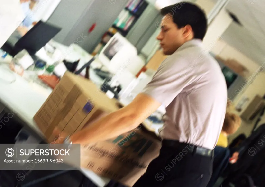 Man placing box on desk, blurred