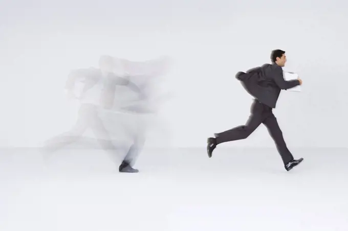 Businessman running with document