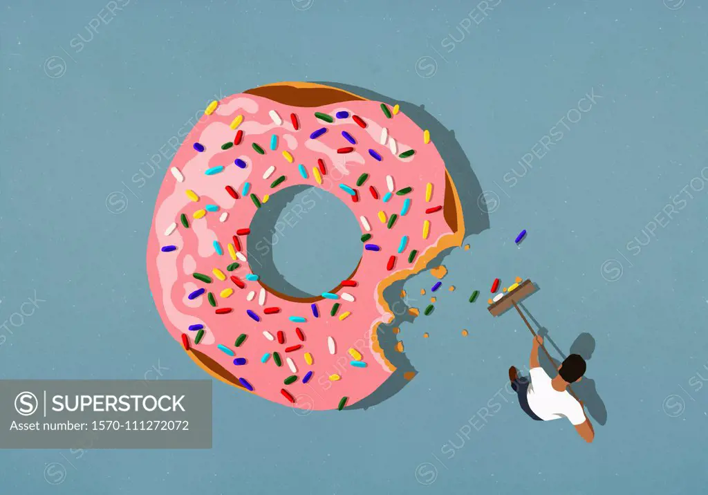 Man with broom sweeping up donut sprinkles