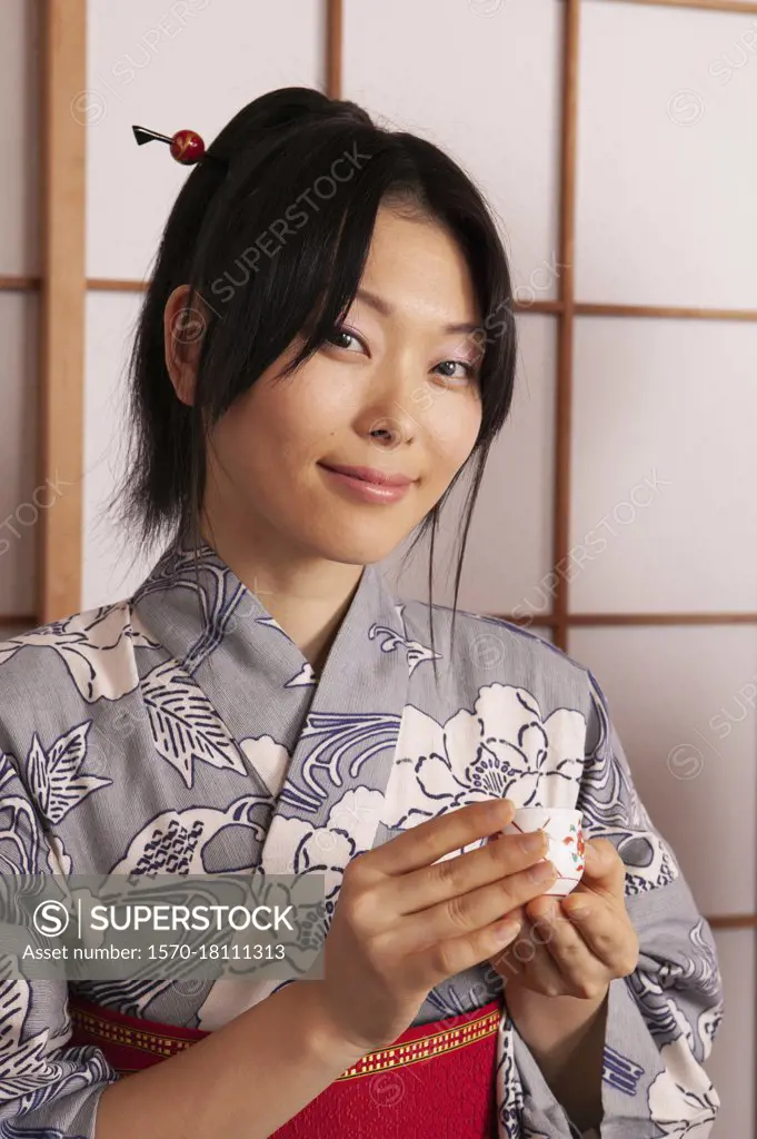 Portrait beautiful young woman in Japanese kimono with tea