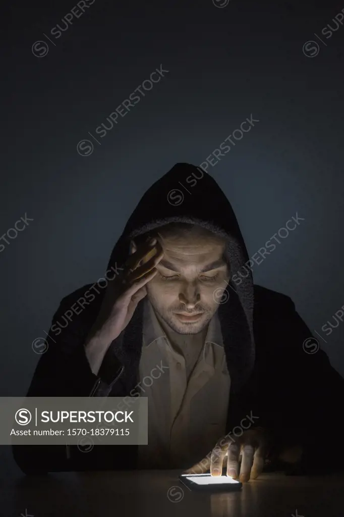 Man using smart phone in dark
