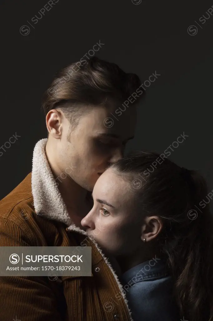 Studio portrait affectionate young couple