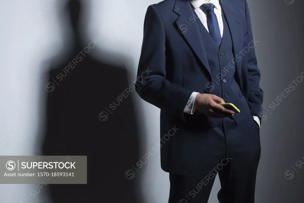 Businessman in suit holding smart phone