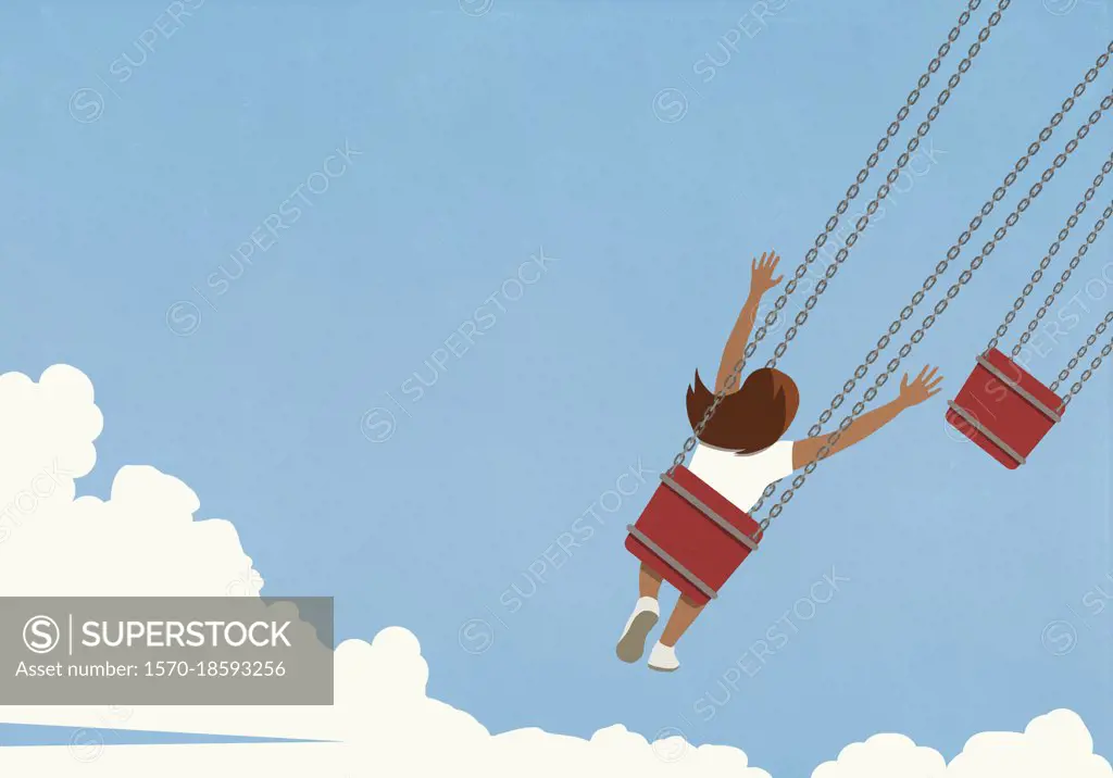 Carefree girl riding chain swing ride against blue sky