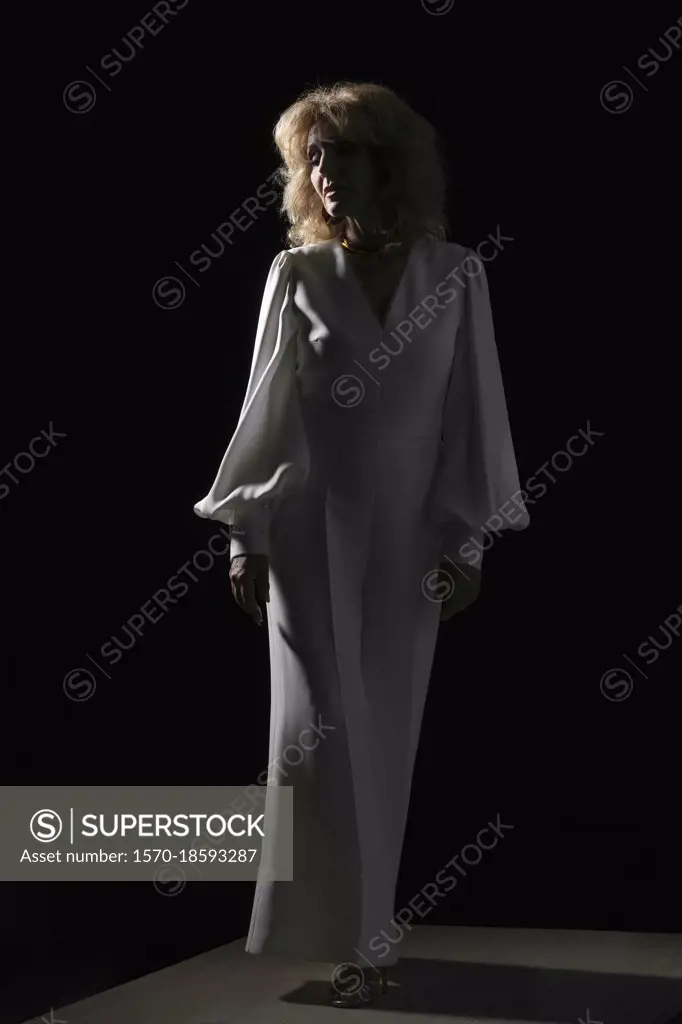 Portrait woman in white against black background