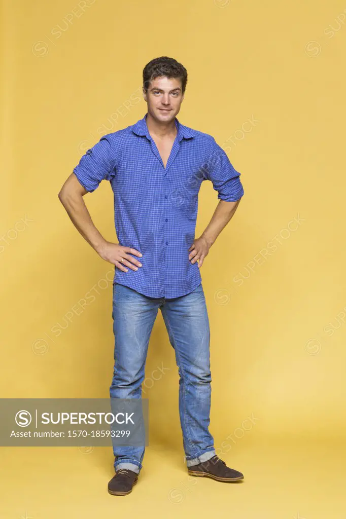 Portrait handsome man in blue on yellow background