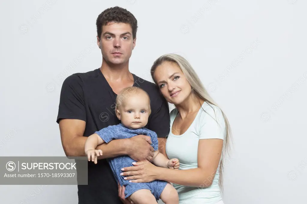 Portrait parents and baby son on white background
