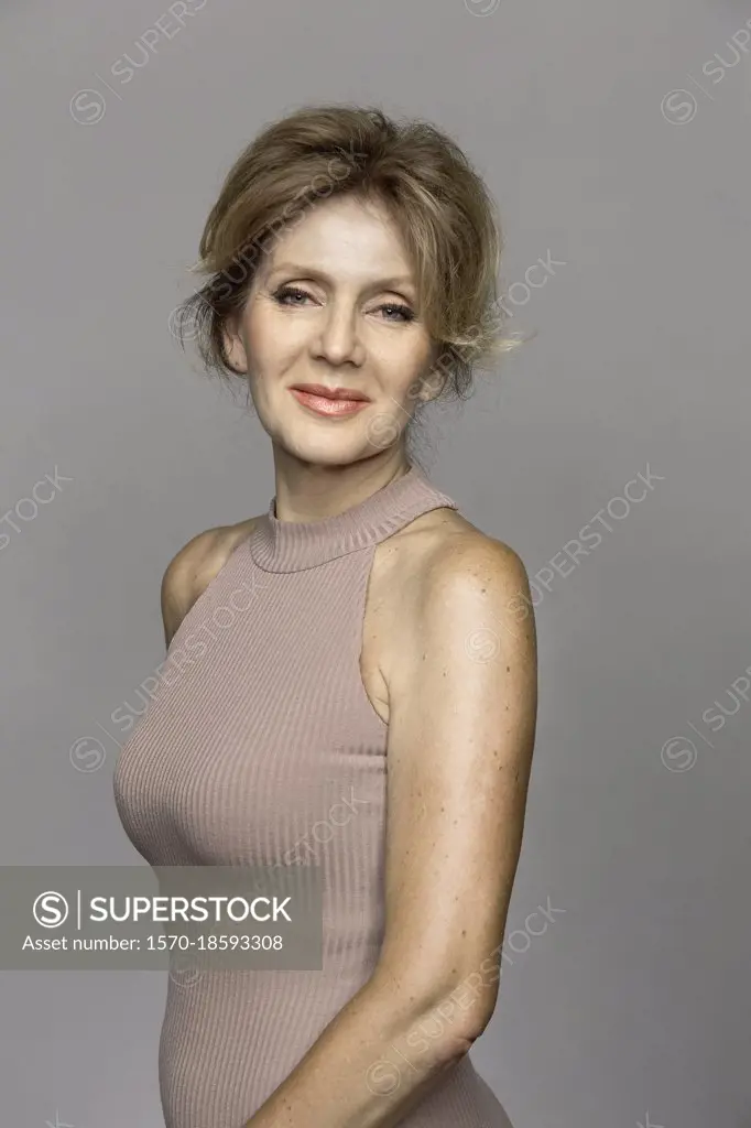 Portrait beautiful mature woman on gray background