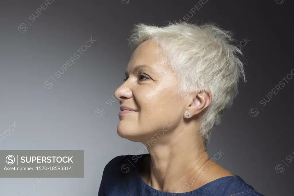 Profile portrait beautiful mature woman with short white hair