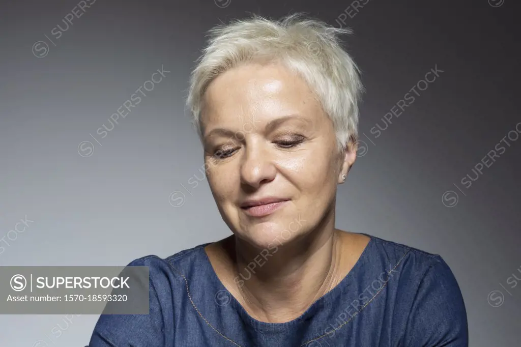 Portrait thoughtful woman with short hair looking down