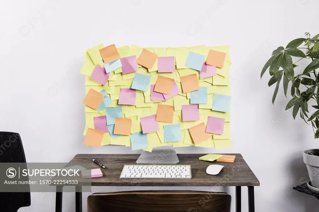 Adhesive notes covering computer in office