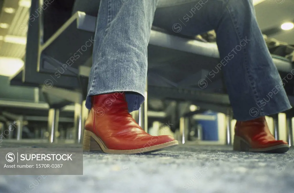 A person wearing red boots