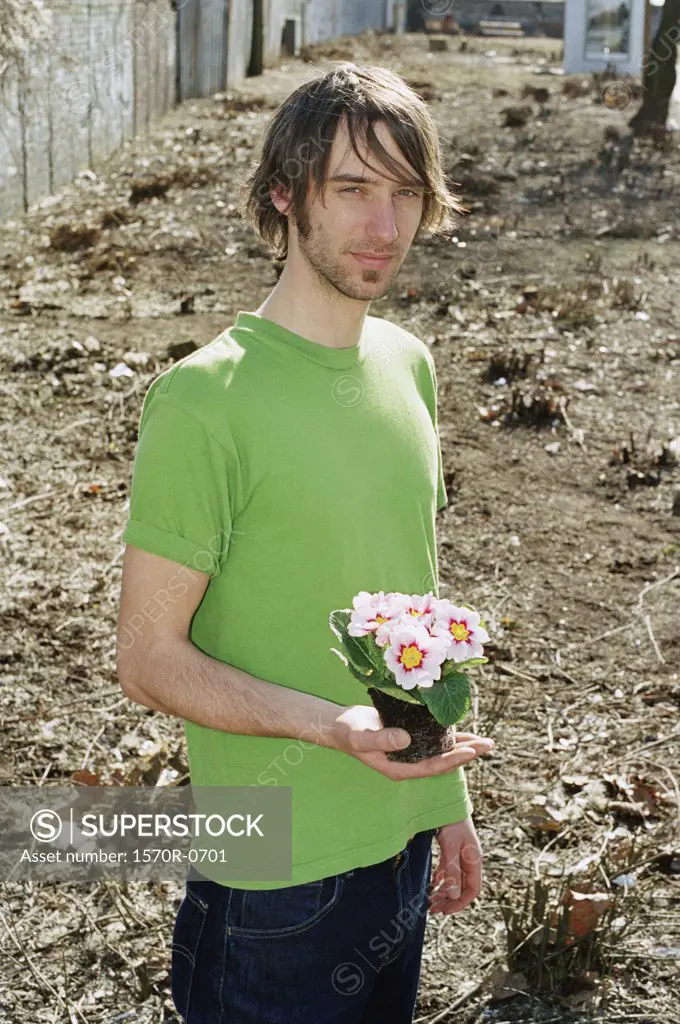 A young man holding flowers