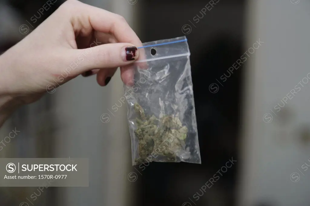 Woman holding bag of marijuana
